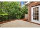 A concrete back patio overlooks a private, wooded backyard area at 238 Langford Valley Way, Cary, NC 27513