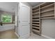 Well-lit bathroom featuring a large soaking tub and custom closet shelving at 238 Langford Valley Way, Cary, NC 27513
