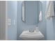 Powder room features a pedestal sink, modern fixtures, and a fresh, updated aesthetic at 238 Langford Valley Way, Cary, NC 27513