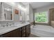 Bathroom with double sink vanity, soaking tub, and ample natural light at 238 Langford Valley Way, Cary, NC 27513