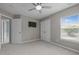 Well-lit bedroom with a mounted TV and double door closet at 238 Langford Valley Way, Cary, NC 27513
