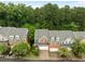 Brick townhomes feature attached garages,dormer windows, and landscaped front yards with mature trees at 238 Langford Valley Way, Cary, NC 27513