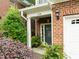 Inviting front entrance with brick siding, trimmed door frame, and lush greenery providing curb appeal at 238 Langford Valley Way, Cary, NC 27513