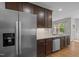 Spacious kitchen features stainless steel appliances, dark wood cabinets, granite countertops, and hardwood floors at 238 Langford Valley Way, Cary, NC 27513