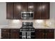 Updated kitchen boasts granite countertops, stainless steel appliances and rich, dark wood cabinetry at 238 Langford Valley Way, Cary, NC 27513