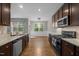Modern kitchen with granite countertops, stainless steel appliances, and hardwood floors, flowing into the dining area at 238 Langford Valley Way, Cary, NC 27513