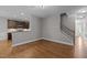 Open-concept space with hardwood floors, staircase, and a breakfast bar, providing connectivity between rooms at 238 Langford Valley Way, Cary, NC 27513
