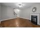 Cozy living room with hardwood floors, fireplace, staircase, and neutral walls providing a warm ambiance at 238 Langford Valley Way, Cary, NC 27513