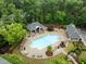 Aerial view of a refreshing community pool surrounded by ample seating and green trees at 238 Langford Valley Way, Cary, NC 27513