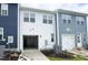 Exterior view of attached garages of townhomes with driveways and partial landscaping at 2422 Whitewing Ln, Wendell, NC 27591