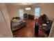 Modestly sized bedroom with wood floors, two windows, a modern ceiling light and personal belongings at 2507 Chapel Hill Rd, Durham, NC 27707