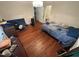 Modestly sized bedroom with wood floors, one window, and personal belongings at 2507 Chapel Hill Rd, Durham, NC 27707
