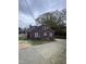 Rear view of a two-story home with a concrete driveway and mature trees at 2507 Chapel Hill Rd, Durham, NC 27707