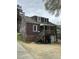 Back of home with porch, staircase, ground level garage and mature landscaping at 2507 Chapel Hill Rd, Durham, NC 27707