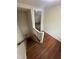 Hallway featuring hardwood floors, a stairwell, and access to the upper floors at 2507 Chapel Hill Rd, Durham, NC 27707