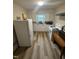 An inside view of the kitchen highlighting white appliances, new floors and white countertops at 2507 Chapel Hill Rd, Durham, NC 27707