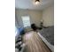 Bedroom featuring natural light, wood floors, a window with blinds, and neutral-colored walls at 2509 Chapel Hill Rd, Durham, NC 27707