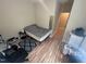 Bedroom featuring wood floors, neutral-colored walls, a mirror and access to an ensuite at 2509 Chapel Hill Rd, Durham, NC 27707