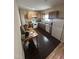Functional kitchen with wood cabinets, essential appliances, and dark tiled flooring at 2509 Chapel Hill Rd, Durham, NC 27707