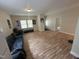 Bright living room with wood-look flooring and ample natural light at 2509 Chapel Hill Rd, Durham, NC 27707