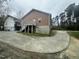 Exterior perspective featuring a back entrance, complemented by lush greenery and outdoor space at 2509 Chapel Hill Rd, Durham, NC 27707