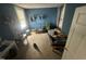 Cozy bedroom with blue walls, a bed, and shelving unit offering a simple living space at 2511 Chapel Hill Rd, Durham, NC 27707