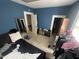 Bedroom featuring blue walls, carpet and two closets for optimal storage at 2511 Chapel Hill Rd, Durham, NC 27707