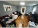 Bedroom featuring hardwood floors, a queen bed, black futon, and natural light at 2511 Chapel Hill Rd, Durham, NC 27707