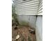 The side of the building showing signs of damage and overgrown plants at 2511 Chapel Hill Rd, Durham, NC 27707