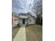 Charming white home with a covered front porch, complemented by a simple, concrete walkway leading to the entrance at 2511 Chapel Hill Rd, Durham, NC 27707
