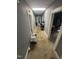Hallway with neutral carpet and access to several rooms throughout the house at 2511 Chapel Hill Rd, Durham, NC 27707