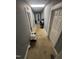 Hallway with neutral carpet and access to several rooms throughout the house at 2511 Chapel Hill Rd, Durham, NC 27707