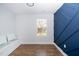 Stylish bedroom featuring a built-in bench, blue accent wall, and natural light at 2517 Newbold St, Raleigh, NC 27603