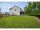 Expansive backyard featuring a well-maintained lawn, fencing, and screened porch at 2521 Heathland Farm Dr, Fuquay Varina, NC 27526