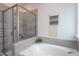 Modern bathroom showcasing a soaking tub, tiled shower, and stylish fixtures at 2521 Heathland Farm Dr, Fuquay Varina, NC 27526