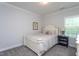 Cozy bedroom with a white-painted bed frame, neutral colors, and a large window providing natural light at 2521 Heathland Farm Dr, Fuquay Varina, NC 27526