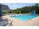 Community pool and lounge area with seating, umbrellas, and a fun slide at 2521 Heathland Farm Dr, Fuquay Varina, NC 27526