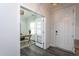 Bright entryway with hardwood floors, leading to a home office with glass doors at 2521 Heathland Farm Dr, Fuquay Varina, NC 27526