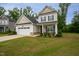 Inviting two-story home with a well-kept lawn, attractive facade and cozy front porch at 2521 Heathland Farm Dr, Fuquay Varina, NC 27526