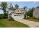 Two-story home with a two car garage, well-maintained lawn, and long driveway at 2521 Heathland Farm Dr, Fuquay Varina, NC 27526