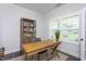 Cozy home office featuring plantation shutters and a classic wooden desk and chair set at 2521 Heathland Farm Dr, Fuquay Varina, NC 27526