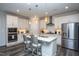 Modern kitchen with quartz countertops, stainless steel appliances, and stylish pendant lighting at 2521 Heathland Farm Dr, Fuquay Varina, NC 27526