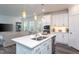 Open concept kitchen with quartz countertops, stainless steel appliances, island and pendant lighting at 2521 Heathland Farm Dr, Fuquay Varina, NC 27526