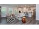 Open-concept living room with modern finishes, hardwood floors, and a kitchen view at 2521 Heathland Farm Dr, Fuquay Varina, NC 27526