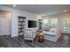 Inviting living room with hardwood floors and lots of light, perfect for relaxing or entertaining at 2521 Heathland Farm Dr, Fuquay Varina, NC 27526