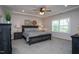 Elegant main bedroom with a dark wood bed frame, stylish decor, and a tray ceiling at 2521 Heathland Farm Dr, Fuquay Varina, NC 27526