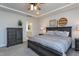 Elegant main bedroom with a dark wood bed frame, stylish decor, tray ceiling, and ensuite bath at 2521 Heathland Farm Dr, Fuquay Varina, NC 27526
