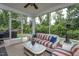 Relaxing screened porch area with stylish wicker furniture and outdoor accents at 2521 Heathland Farm Dr, Fuquay Varina, NC 27526