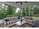 Inviting screened-in porch with comfortable seating and view of the wooded backyard at 2521 Heathland Farm Dr, Fuquay Varina, NC 27526