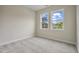 Bedroom featuring neutral walls, plush carpeting, and two large windows at 2537 Cedar Hedge Ct, Apex, NC 27523